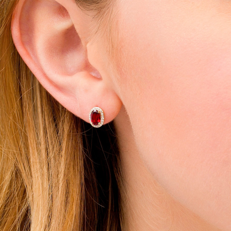 Main Image 2 of Oval Garnet and 0.088 CT. T.W. Diamond Frame Stud Earrings in 10K Gold