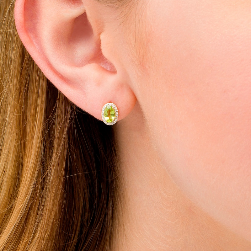 Main Image 2 of Oval Peridot and 0.088 CT. T.W. Diamond Frame Stud Earrings in 10K Gold