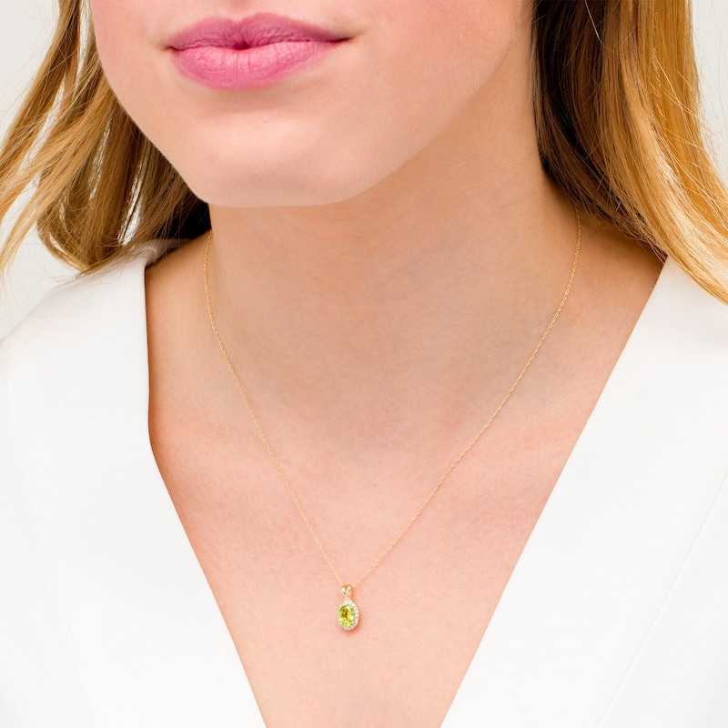 Main Image 2 of Oval Peridot and 0.08 CT. T.W. Diamond Frame Twisted Split Bail Pendant in 10K Gold
