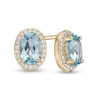 Thumbnail Image 0 of Oval Swiss Blue Topaz and 0.088 CT. T.W. Diamond Frame Stud Earrings in 10K Gold