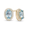 Thumbnail Image 1 of Oval Swiss Blue Topaz and 0.088 CT. T.W. Diamond Frame Stud Earrings in 10K Gold