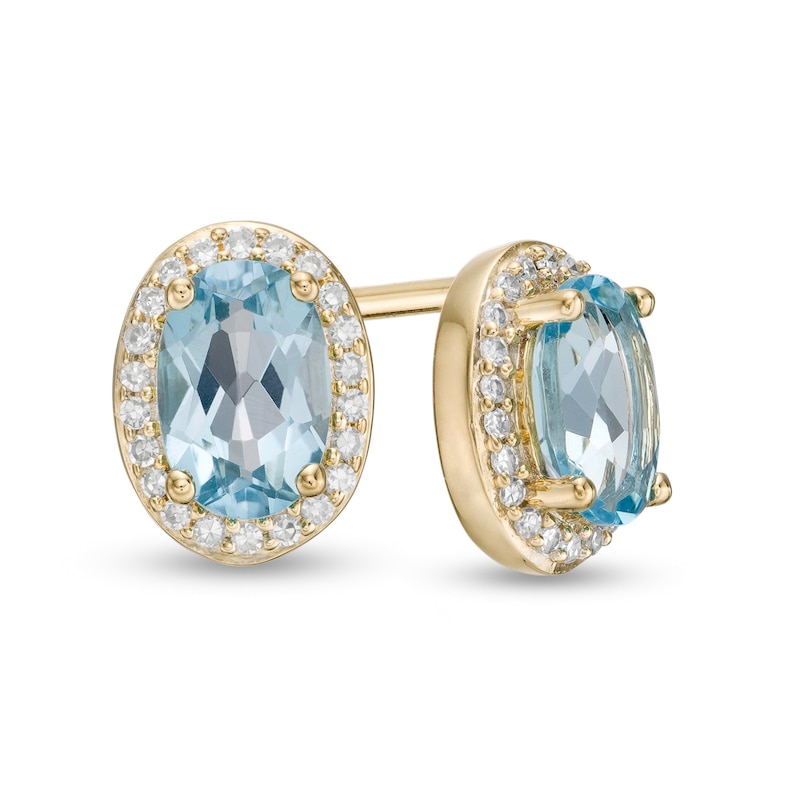 Main Image 1 of Oval Swiss Blue Topaz and 0.088 CT. T.W. Diamond Frame Stud Earrings in 10K Gold