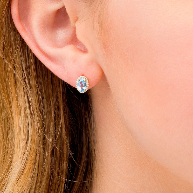 Main Image 2 of Oval Swiss Blue Topaz and 0.088 CT. T.W. Diamond Frame Stud Earrings in 10K Gold
