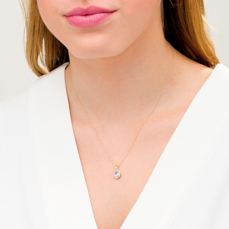 Main Image 2 of Oval Swiss Blue Topaz and 0.08 CT. T.W. Diamond Frame Twisted Split Bail Pendant in 10K Gold