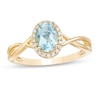 Thumbnail Image 1 of Oval Swiss Blue Topaz and 0.08 CT. T.W. Diamond Frame Twist Shank Ring in 10K Gold