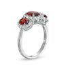 Thumbnail Image 2 of Oval Garnet and White Lab-Created Sapphire Frame Three Stone Ring in Sterling Silver