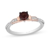 Thumbnail Image 0 of Enchanted Disney Snow White 5.0mm Garnet and 0.18 CT. T.W. Diamond Bow Promise Ring in Sterling Silver and 10K Rose Gold