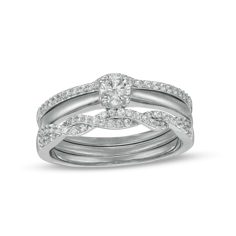 0.45 CT. T.W. Diamond Twist Three Piece Bridal Set in 10K Gold (J/I3