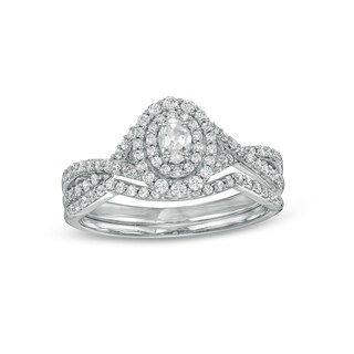 0.58 CT. T.W. Oval Diamond Double Frame Twist Shank Bridal Set in 10K White Gold (I/I2)