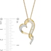 0.145 CT. T.W. Baguette and Round Diamond Twist Heart Pendant in 10K Gold