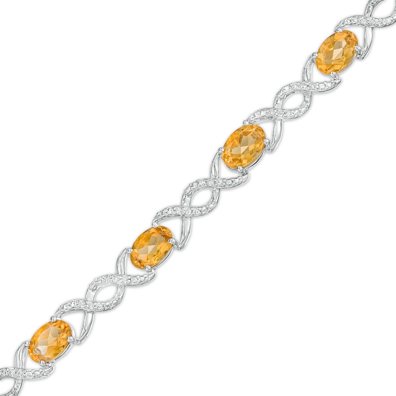 Oval Citrine and 0.18 CT. T.W. Diamond Infinity Ribbon Link Line Bracelet in Sterling Silver – 7.5"|Peoples Jewellers