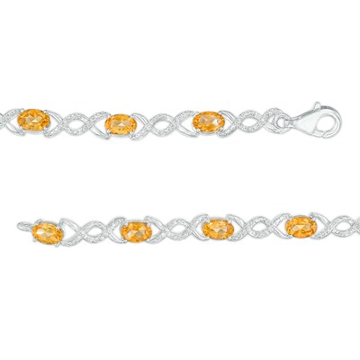 Oval Citrine and 0.18 CT. T.W. Diamond Infinity Ribbon Link Line Bracelet in Sterling Silver – 7.5"