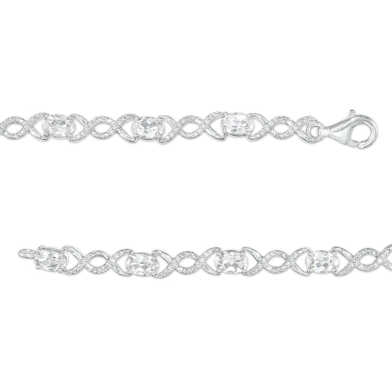 Main Image 3 of Oval White Lab-Created Sapphire and 0.18 CT. T.W. Diamond Infinity Ribbon Link Line Bracelet in Sterling Silver – 7.5"
