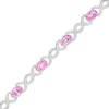 Thumbnail Image 1 of Oval Pink Lab-Created Sapphire and 0.18 CT. T.W. Diamond Infinity Ribbon Link Line Bracelet in Sterling Silver – 7.5"