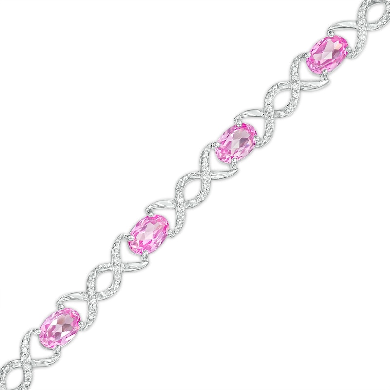 Main Image 1 of Oval Pink Lab-Created Sapphire and 0.18 CT. T.W. Diamond Infinity Ribbon Link Line Bracelet in Sterling Silver – 7.5"