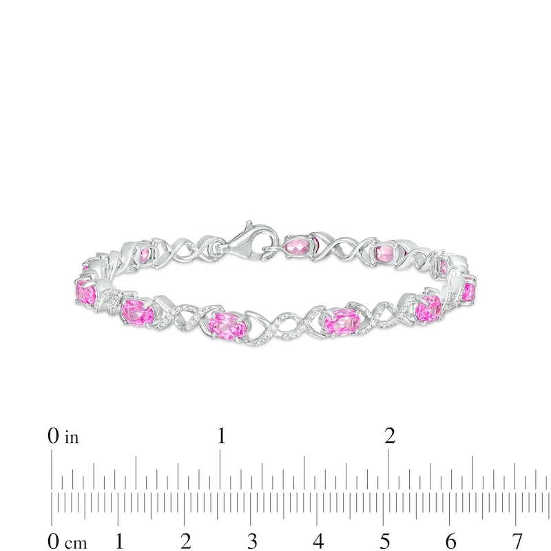 Main Image 4 of Oval Pink Lab-Created Sapphire and 0.18 CT. T.W. Diamond Infinity Ribbon Link Line Bracelet in Sterling Silver – 7.5"
