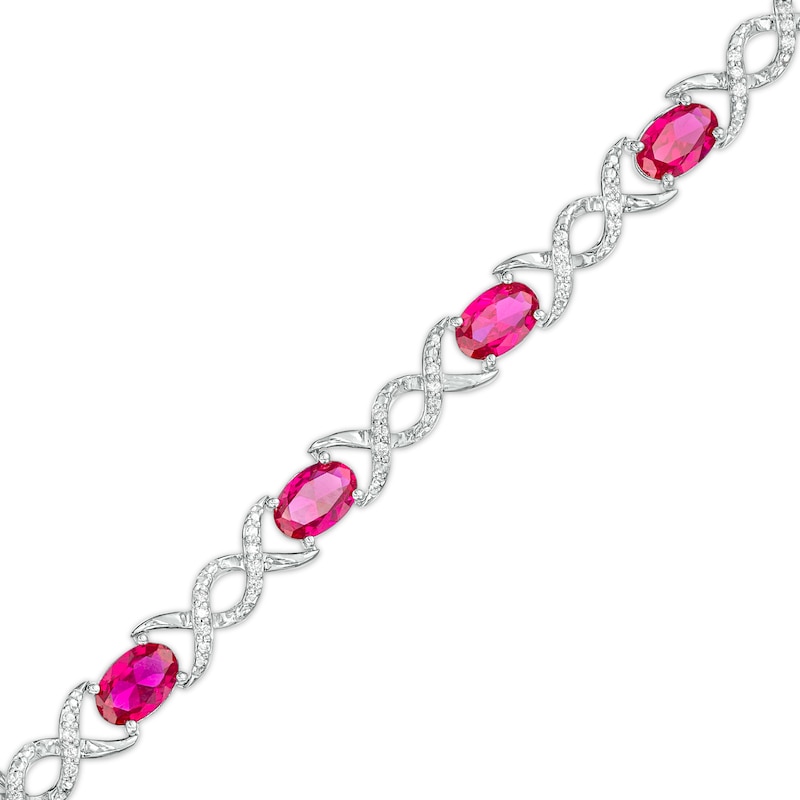 Oval Lab-Created Ruby and 0.18 CT. T.W. Diamond Infinity Ribbon Link Line Bracelet in Sterling Silver – 7.5"