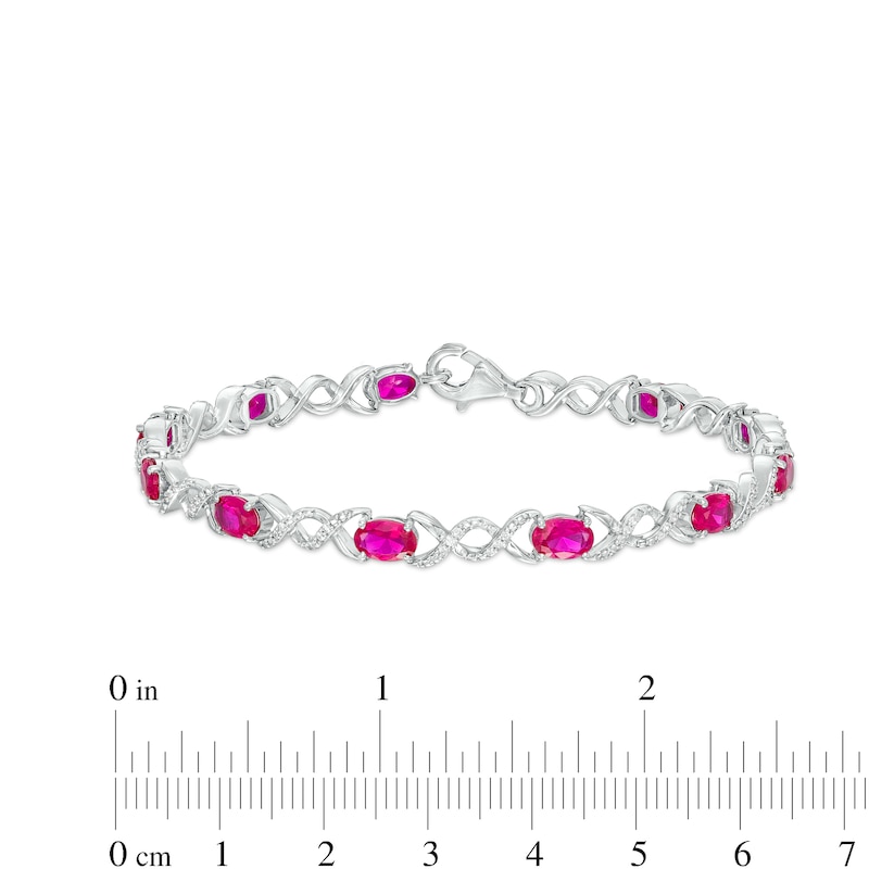 Oval Lab-Created Ruby and 0.18 CT. T.W. Diamond Infinity Ribbon Link Line Bracelet in Sterling Silver – 7.5"|Peoples Jewellers