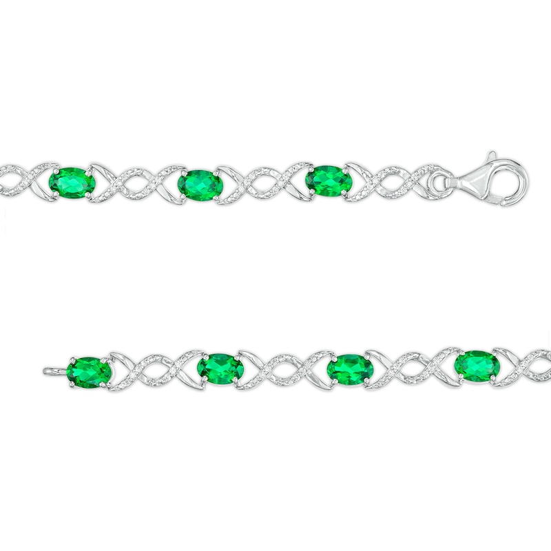 Main Image 3 of Oval Lab-Created Emerald and 0.18 CT. T.W. Diamond Infinity Ribbon Link Line Bracelet in Sterling Silver – 7.5"