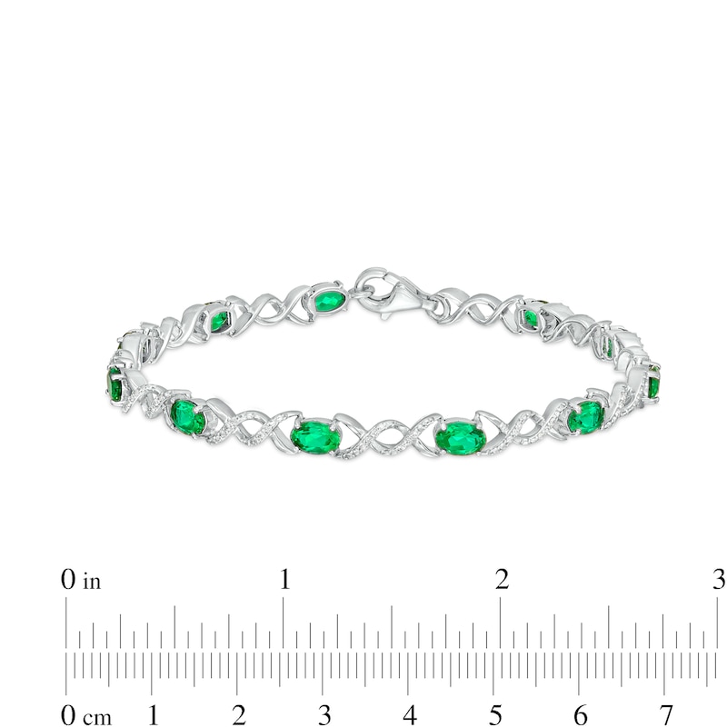 Main Image 4 of Oval Lab-Created Emerald and 0.18 CT. T.W. Diamond Infinity Ribbon Link Line Bracelet in Sterling Silver – 7.5"