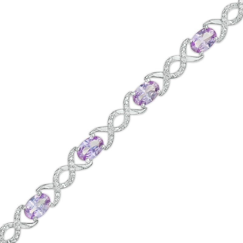 Main Image 1 of Oval Lab-Created Alexandrite and 0.18 CT. T.W. Diamond Infinity Ribbon Link Line Bracelet in Sterling Silver – 7.5"