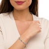 Thumbnail Image 2 of Oval Blue Topaz and 0.18 CT. T.W. Diamond Infinity Ribbon Link Line Bracelet in Sterling Silver – 7.5"