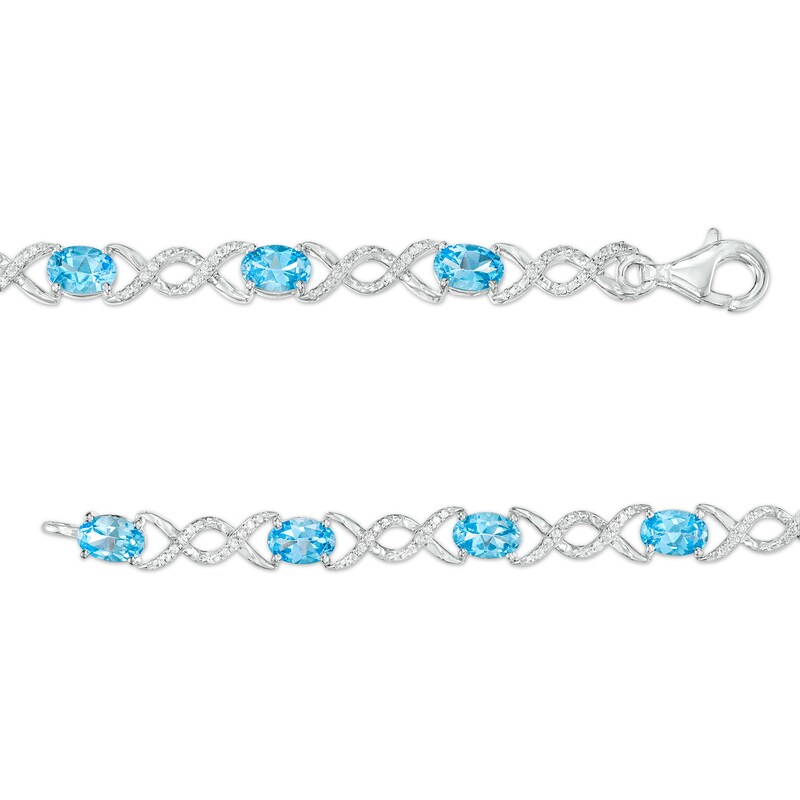 Main Image 3 of Oval Blue Topaz and 0.18 CT. T.W. Diamond Infinity Ribbon Link Line Bracelet in Sterling Silver – 7.5"