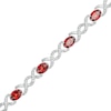 Thumbnail Image 1 of Oval Garnet and 0.18 CT. T.W. Diamond Infinity Ribbon Link Line Bracelet in Sterling Silver – 7.5"