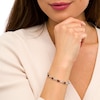 Thumbnail Image 2 of Oval Garnet and 0.18 CT. T.W. Diamond Infinity Ribbon Link Line Bracelet in Sterling Silver – 7.5"