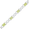 Thumbnail Image 1 of Oval Peridot and 0.18 CT. T.W. Diamond Infinity Ribbon Link Line Bracelet in Sterling Silver – 7.5"