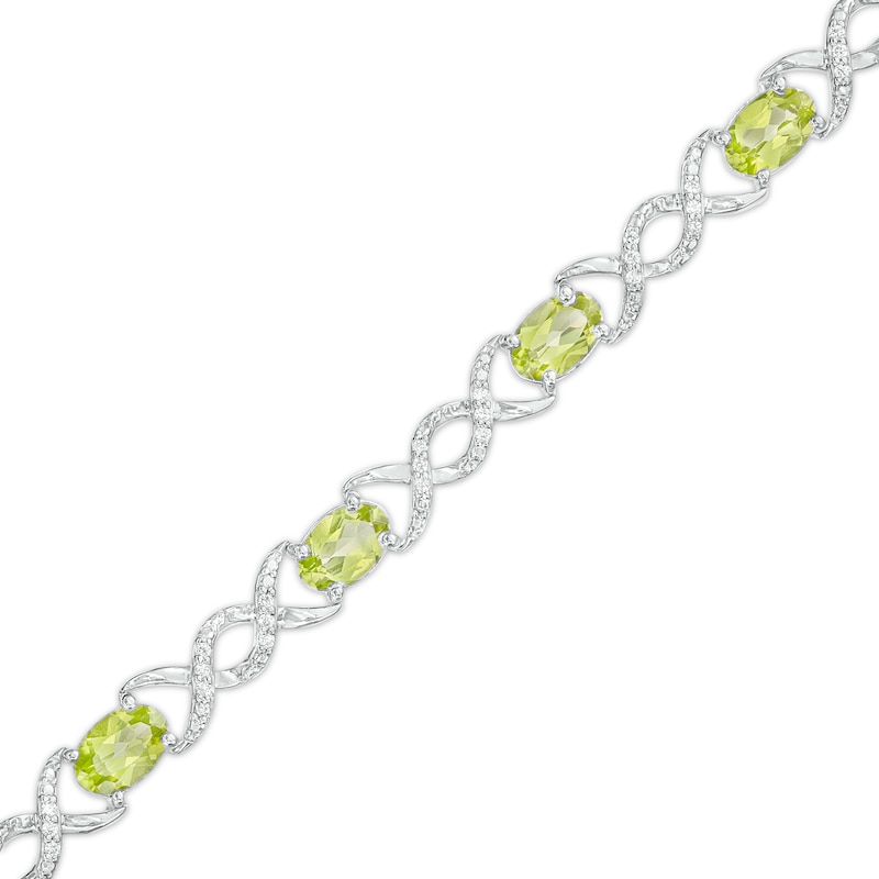 Main Image 1 of Oval Peridot and 0.18 CT. T.W. Diamond Infinity Ribbon Link Line Bracelet in Sterling Silver – 7.5"