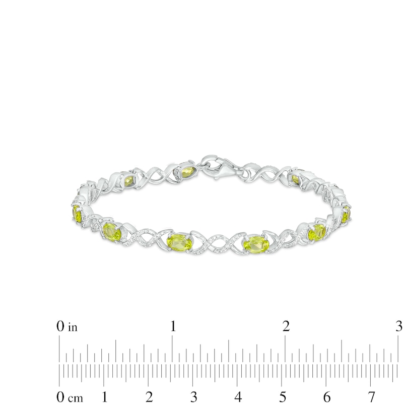 Main Image 4 of Oval Peridot and 0.18 CT. T.W. Diamond Infinity Ribbon Link Line Bracelet in Sterling Silver – 7.5"