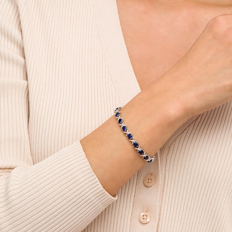 Main Image 2 of 4.5mm Blue Lab-Created Sapphire and 0.14 CT. T.W. Diamond Alternating "XO" Line Bracelet in Sterling Silver – 7.5"