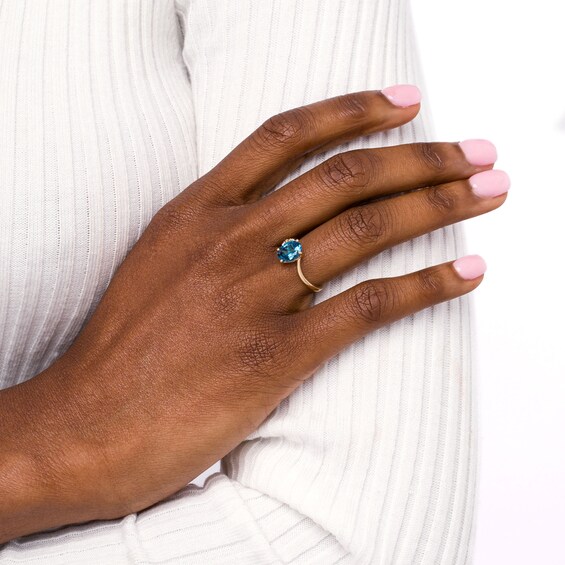 Oval London Blue Topaz and Diamond Accent Bypass Flower Ring in 10K Gold