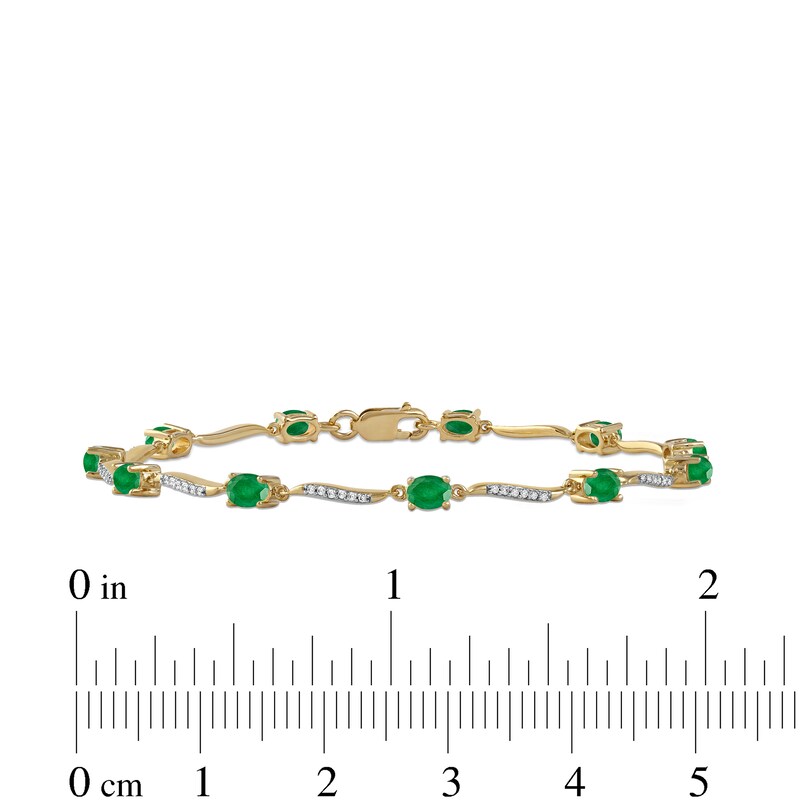 Oval Emerald and 0.16 CT. T.W. Diamond Wave Link Alternating Line Bracelet in 14K Gold – 7.25"