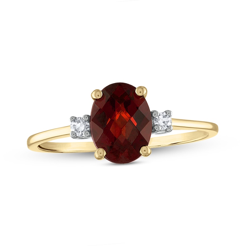 Oval Faceted Garnet and 0.05 CT. T.W. Diamond Side Accent Ring in 14K Gold
