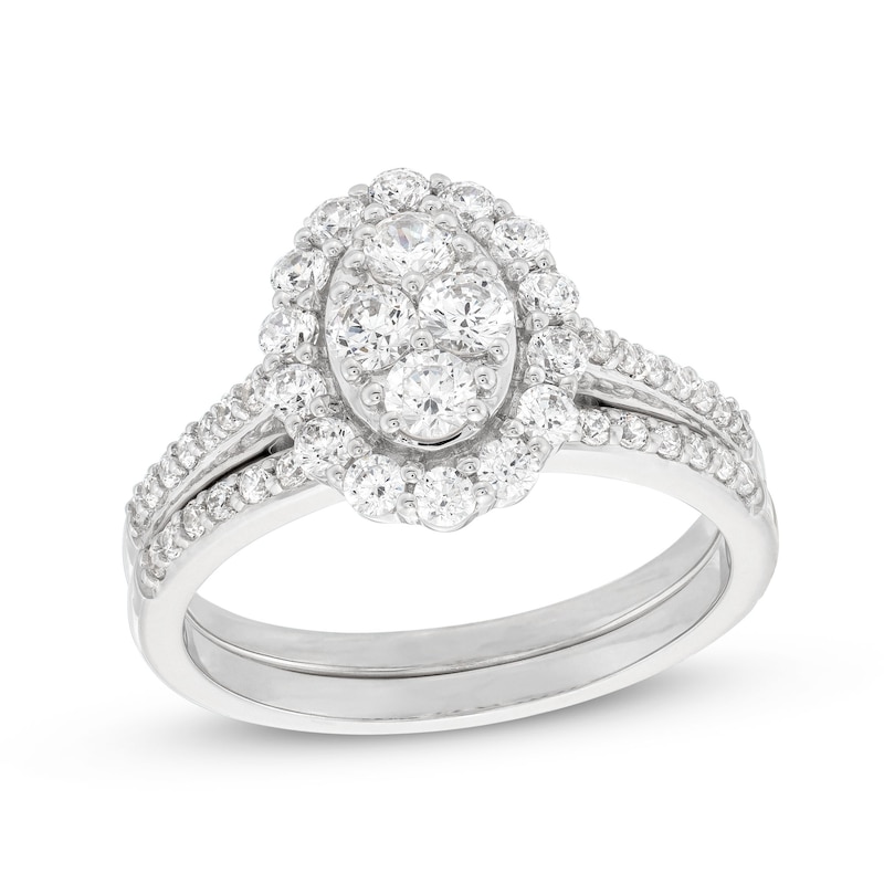 0.95 CT. T.W. Oval-Shaped Multi-Diamond Frame Bridal Set in 10K White Gold (J/I3)