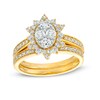 0.95 CT. T.W. Oval-Shaped Multi-Diamond Alternating Flower Frame Bridal Set in 10K Gold (J/I3)
