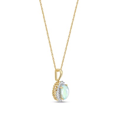 Oval Opal and 0.115 CT. T.W. Baguette and Round Diamond Starburst Frame Pendant in 10K Gold
