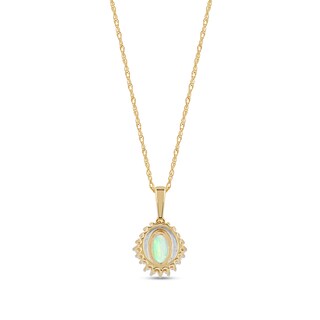 Oval Opal and 0.115 CT. T.W. Baguette and Round Diamond Starburst Frame Pendant in 10K Gold