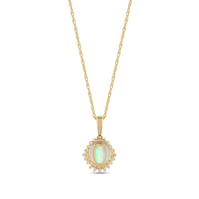 Oval Opal and 0.115 CT. T.W. Baguette and Round Diamond Starburst Frame Pendant in 10K Gold