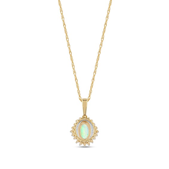 Oval Opal and 0.115 CT. T.W. Baguette and Round Diamond Starburst Frame Pendant in 10K Gold