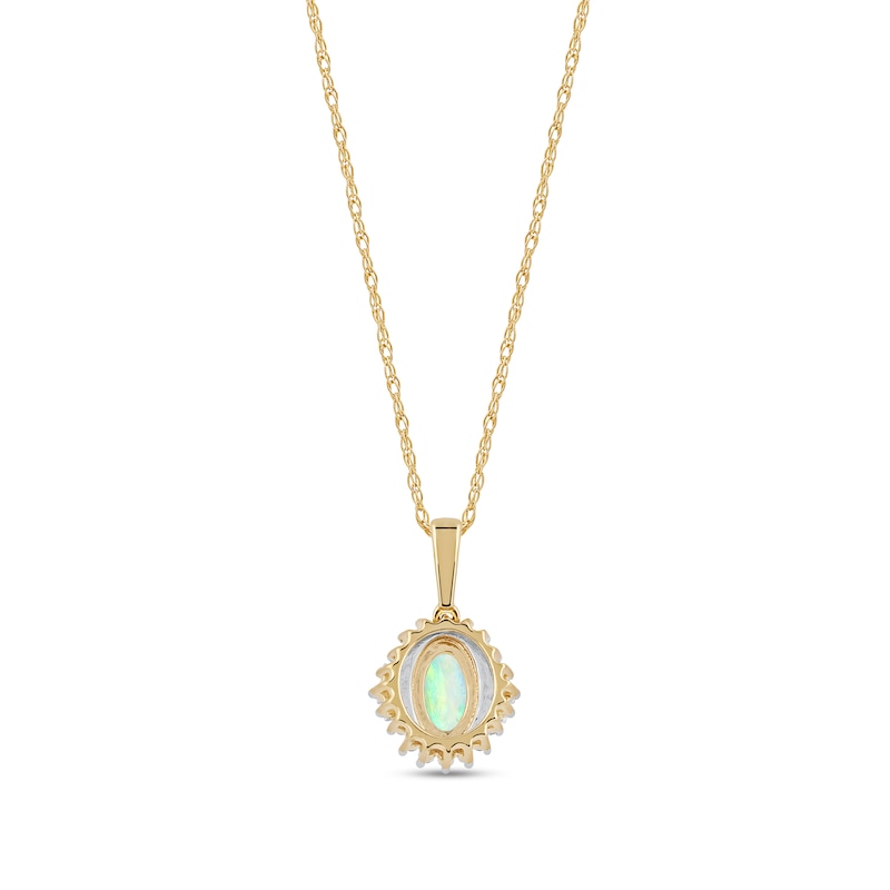 Oval Opal and 0.115 CT. T.W. Baguette and Round Diamond Starburst Frame Pendant in 10K Gold