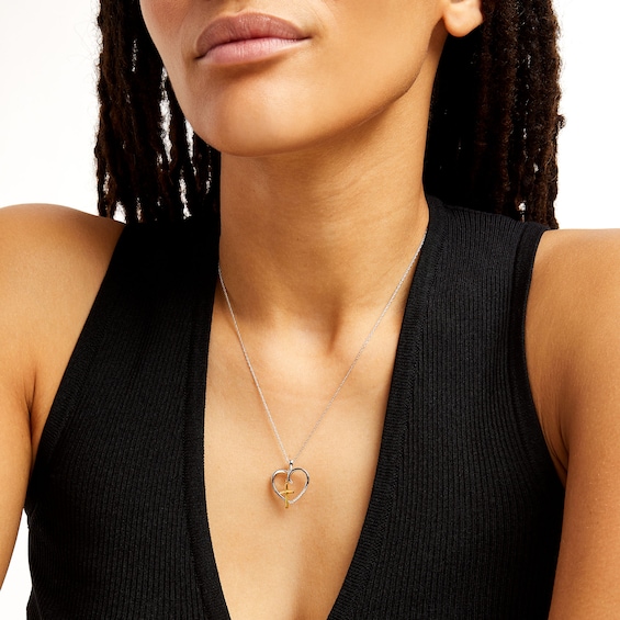0.05 CT. T.W. Diamond Heart with Cross Charm Pendant in Sterling Silver and 10K Gold