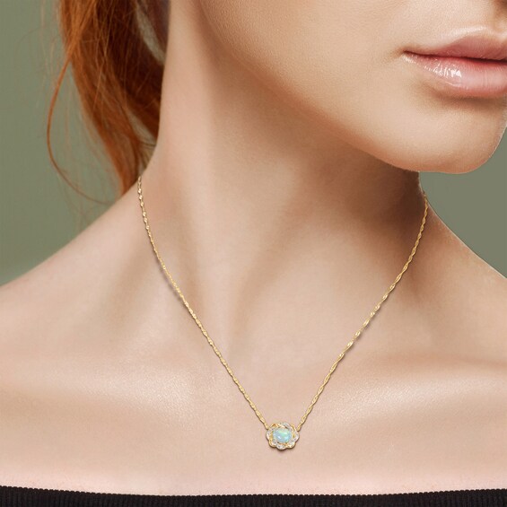 Sideways Oval Blue Opal and 0.08 CT. T.W. Diamond Twist Frame Necklace in 10K Gold - 17"