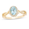 Thumbnail Image 1 of Previously Owned - Oval Swiss Blue Topaz and 0.08 CT. T.W. Diamond Frame Twist Shank Ring in 10K Gold