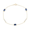 Thumbnail Image 1 of Oval Blue Lab-Created Sapphire and 0.18 CT. T.W. Certified Lab-Grown Diamond Station Bracelet in 10K Gold - 7.25”