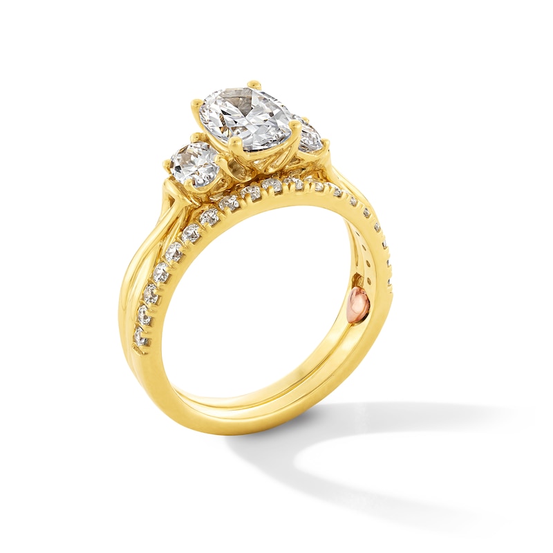 Perfect Fit 1.75 CT. T.W. Oval Certified Lab-Grown Diamond Three Stone Twist Shank Bridal Set in 14K Gold (F/VS2)