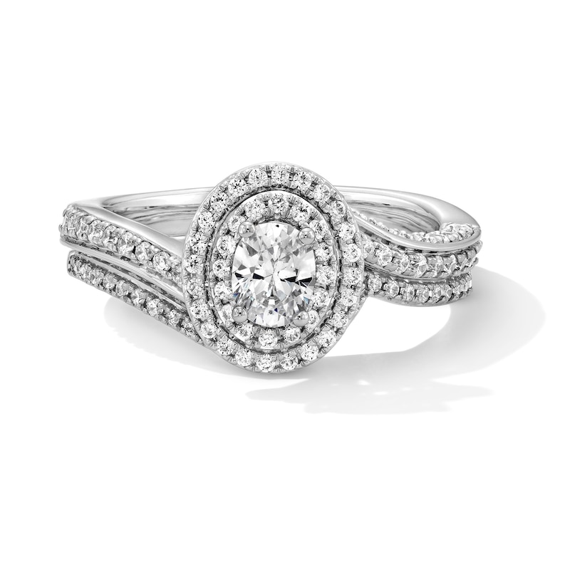 1.00 CT. T.W. Oval Canadian Certified Centre Diamond Double Frame Bypass Bridal Set in 14K White Gold (I/I1)