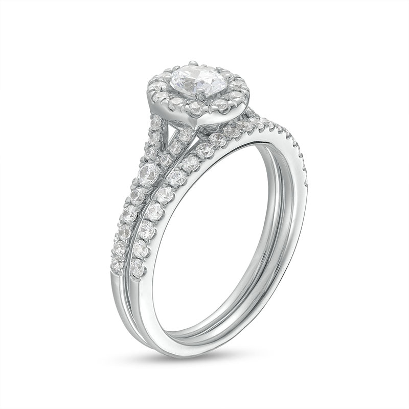 Previously Owned - 0.95 CT. T.W. Oval Diamond Frame Bridal Set in 14K White Gold (I/I1)
